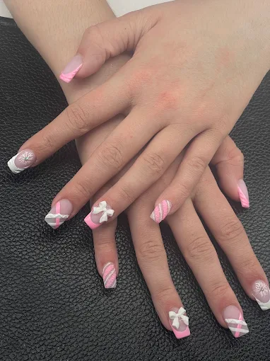 Long pink nails with white French tips and bow accents