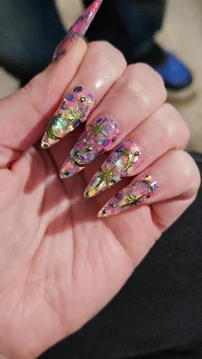 Long floral nail art with layered color and gold details